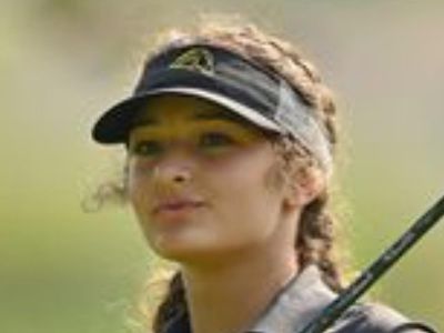 Meadow Rolence is holding the golf stick in the picture.